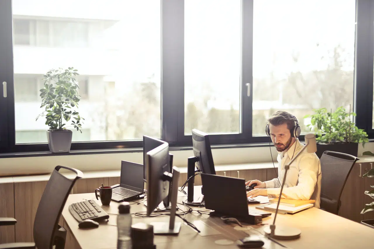 Photo of man at computer retuning phone calls from contact us page